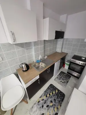 a small kitchen with a sink and a stove at Apartman Magi in Prnjavor