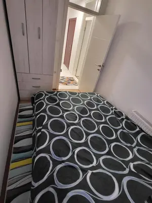 a room with a bed in the middle of a room at Apartman Magi in Prnjavor