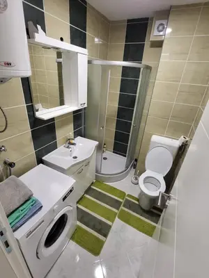 a bathroom with a toilet sink and a shower at Apartman Magi in Prnjavor