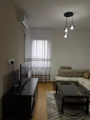 a living room with a couch and a coffee table at Apartment Lofty Dreams in Banja Luka