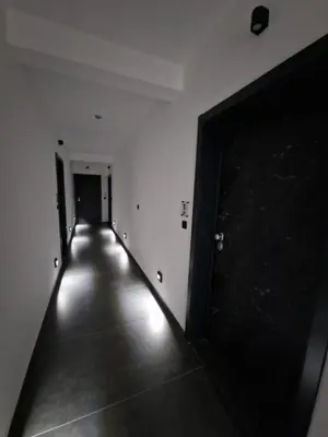 an empty hallway with a long hallway with a door at Apartment Lofty Dreams in Banja Luka