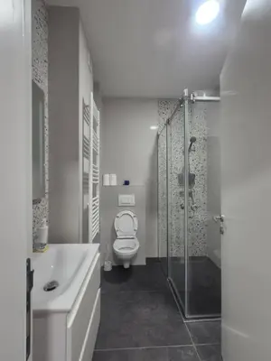 a white bathroom with a toilet and a shower at Apartment Lofty Dreams in Banja Luka