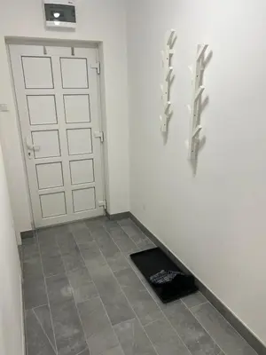 a room with a garage door and a tile floor at Apartman Ivano Kupres in Kupres