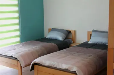 two beds sitting next to each other in a bedroom at Hostel Sobe Popović in Nova Bila