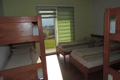 two bunk beds in a room with a window at Hostel Sobe Popović in Nova Bila