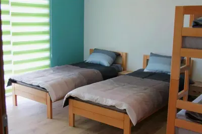 two beds sitting next to each other in a room at Hostel Sobe Popović in Nova Bila