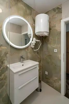 a bathroom with a sink and a mirror at Apartmani Deluxe in Sanski most