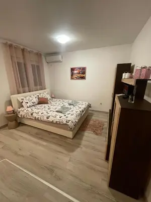 a bedroom with a bed and a wooden floor at Studio 34 in Doboj