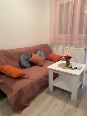 a couch with pillows and a table in a living room at Studio 34 in Doboj