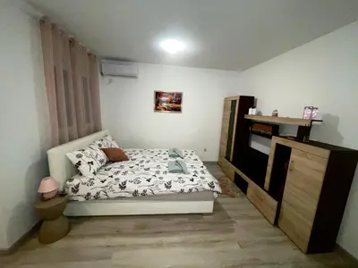 a small bedroom with a bed and a dresser at Studio 34 in Doboj