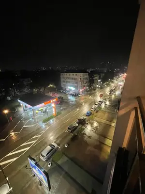 a city street at night with a gas station at Studio 34 in Doboj