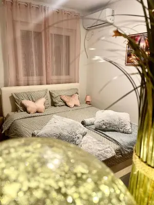 two beds in a room with pink pillows at Studio 34 in Doboj