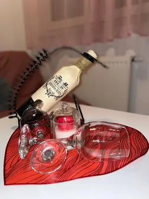 a red tray with wine bottles and glasses on a table at Studio 34 in Doboj