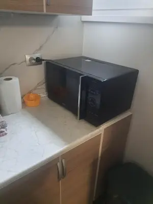 a microwave sitting on top of a kitchen counter at Apartman Bato in Banja Luka