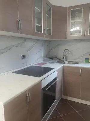 a kitchen with a sink and a stove top oven at Apartman Bato in Banja Luka
