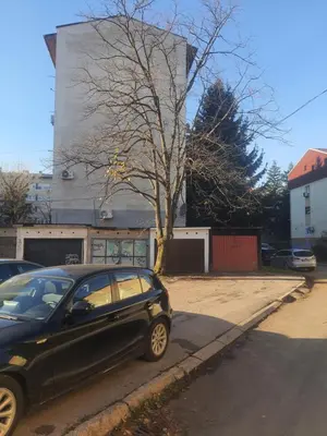 a black car parked on the side of a street at Apartman Bato in Banja Luka