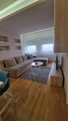 a living room with a couch and a table at Apartman Savanovic sa garazom in Banja Luka