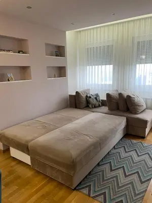 a large bed in a living room with a couch at Apartman Savanovic sa garazom in Banja Luka
