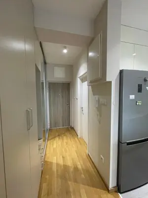 a hallway of an empty apartment with a refrigerator at Apartman Savanovic sa garazom in Banja Luka