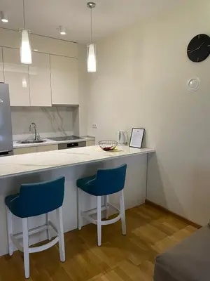 a kitchen with two blue chairs and a counter at Apartman Savanovic sa garazom in Banja Luka