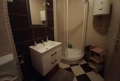 a bathroom with a sink and a shower and a toilet at Ugodan Kutak in Kupres