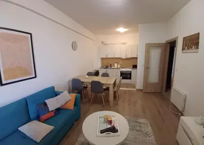 a living room with a blue couch and a table at Ugodan Kutak in Kupres