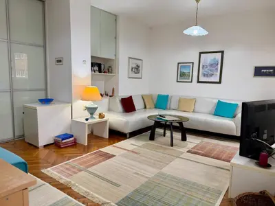 a living room with a couch and a table at Apartments by BENCO in Ivišovo Greblje