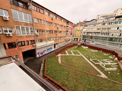 a courtyard in the middle of a city with buildings at Apartments by BENCO in Ivišovo Greblje