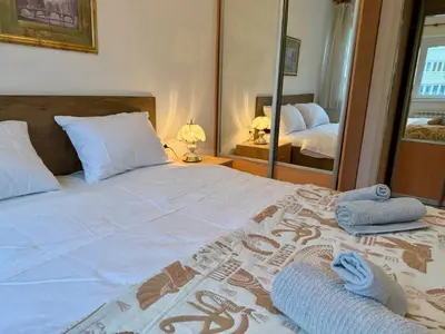 a bedroom with a large bed with towels on it at Apartments by BENCO in Ivišovo Greblje