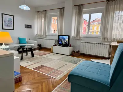 a living room with a couch and a tv at Apartments by BENCO in Ivišovo Greblje