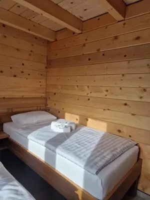 a bedroom with a bed in a wooden room at Kozara Panoramic Resort in Bosanska Gradiška