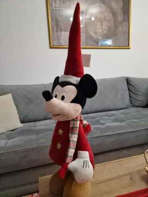 a mickey mouse stuffed animal wearing a christmas elf costume at Apartman Miki in Vlasic