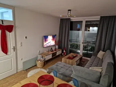 a living room with a couch and a tv at Apartman Miki in Vlasic