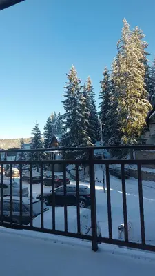 a group of cars parked in a parking lot covered in snow at Apartman Miki in Vlasic
