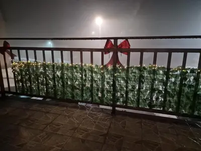a balcony with a fence with flowers on it at Apartman Miki in Vlasic