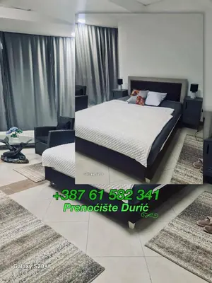 a bedroom with a bed and a couch and rugs at Prenoćište Durić in Cazin