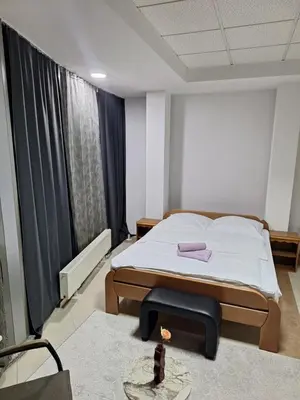 a bedroom with a bed and a table in it at Prenoćište Durić in Cazin