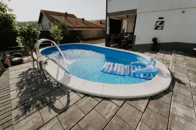 a pool with a water slide in a yard at Villa Žigić