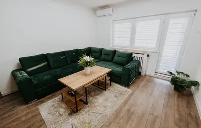 a green couch in a living room with a table at Villa Žigić