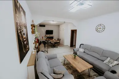 a living room with couches and a dining room at Villa Žigić