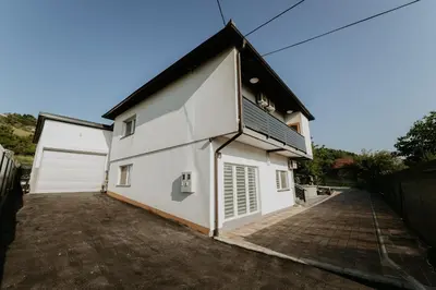 a large white building with a garage at Villa Žigić