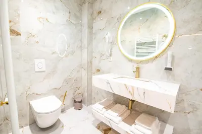 a bathroom with a sink and a toilet at Hotel Story in Žepče