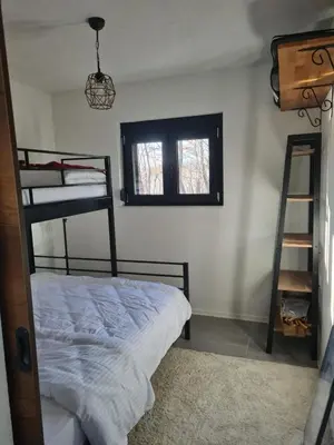 a bedroom with two bunk beds and a ladder at Villa Aria in Bosanska Krupa