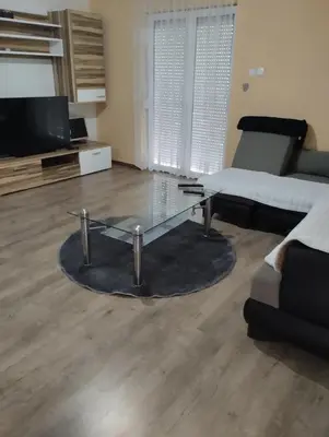 a living room with a glass table and a couch at Apartman Mona Liza Banja Luka in Banja Luka