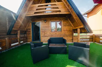 a log cabin with two chairs and a table at Una Relax in Vajagići