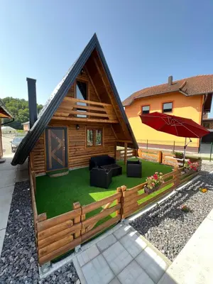 a log house with a yard with a lawn at Una Relax in Vajagići