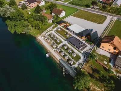 an aerial view of a house next to the water at Una Relax in Vajagići