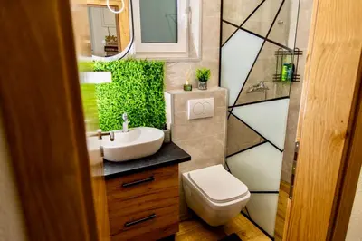 a bathroom with a white sink and a toilet at SkyLux Vlašić in Šišava