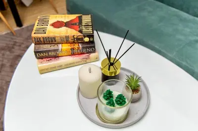 a table with a plate with a candle and a book at SkyLux Vlašić in Šišava