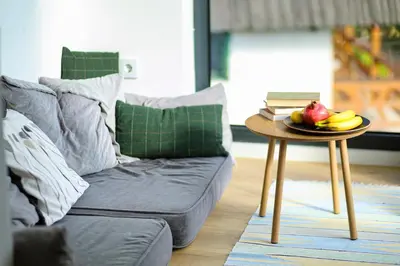 a couch with a table with a plate of fruit on it at Viva Vlasic - Apartman i vikendica in Šišava